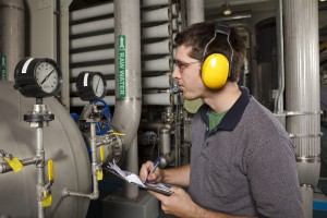 man monitoring gas tank