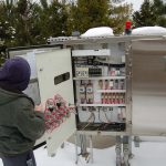 Plant personnel inspecting lift station Control panel