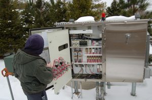 Plant personnel inspecting lift station Control panel