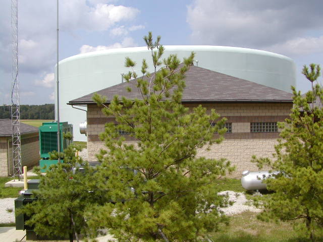 Municipal water booster station next to a storage tank